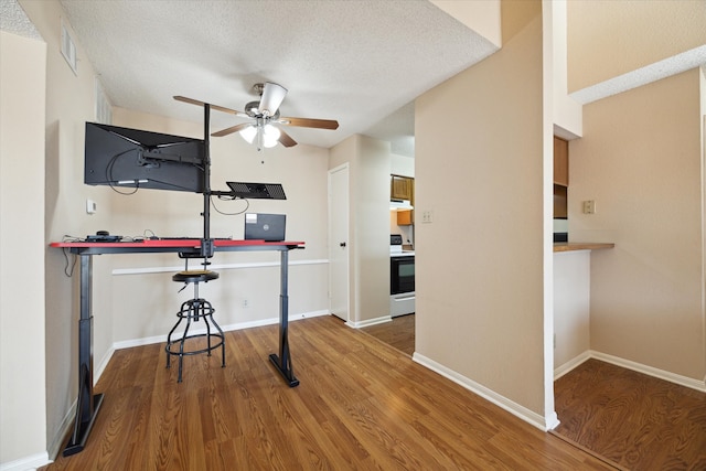 interior space with ceiling fan, hardwood / wood-style floors, and a textured ceiling