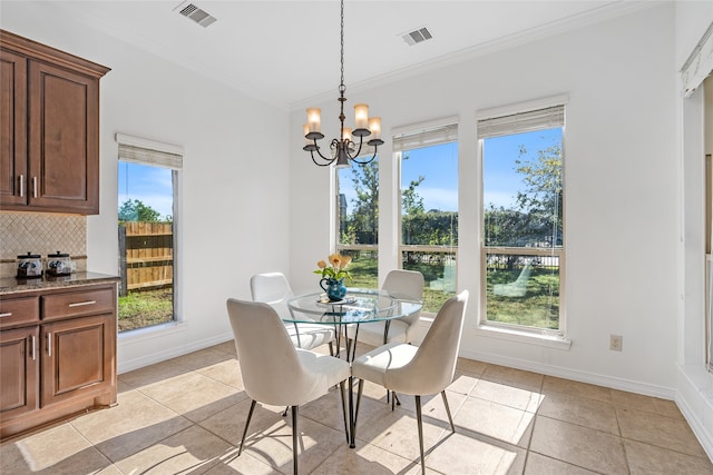 tiled dining area featuring crown molding and a healthy amount of sunlight