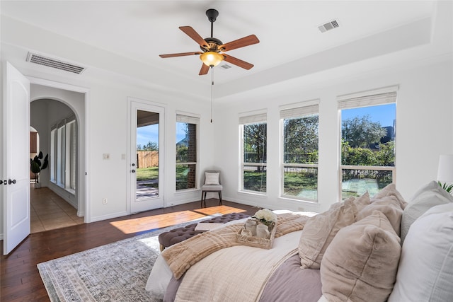 bedroom featuring access to outside, dark hardwood / wood-style floors, and ceiling fan