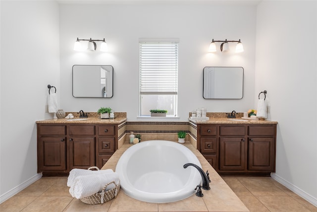 bathroom with tile patterned floors, a tub to relax in, and vanity