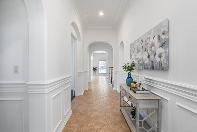 hall featuring crown molding and light tile patterned floors