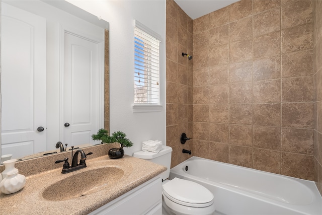 full bathroom featuring tiled shower / bath combo, toilet, and vanity