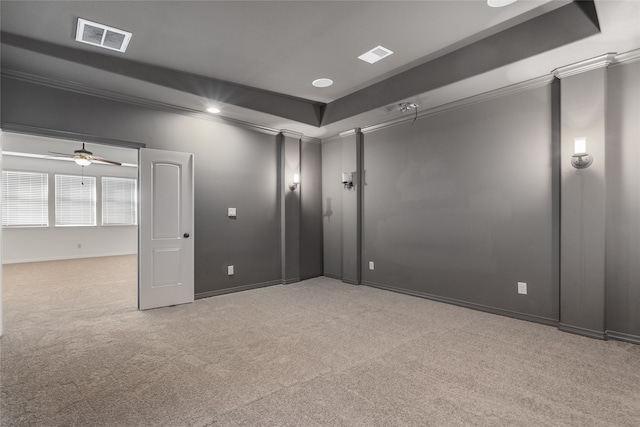 carpeted spare room with ceiling fan and ornamental molding