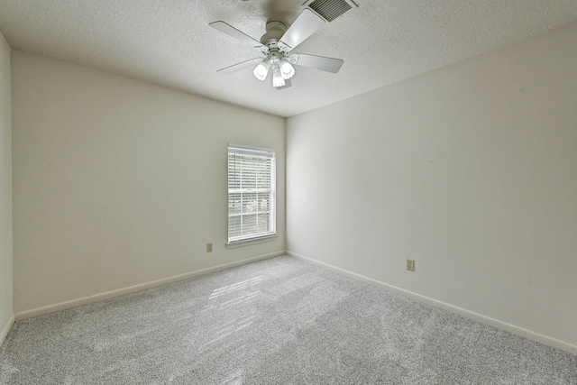 carpeted spare room featuring a textured ceiling