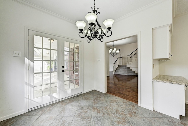 unfurnished dining area with french doors, light wood-type flooring, an inviting chandelier, and crown molding