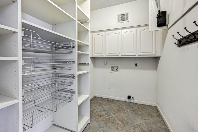 washroom with cabinets, hookup for a washing machine, and electric dryer hookup