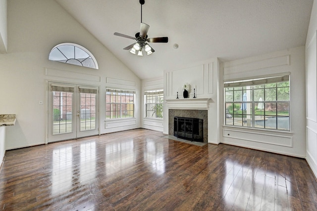 unfurnished living room featuring ceiling fan, a fireplace, high vaulted ceiling, and dark wood-type flooring