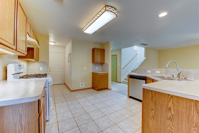 kitchen with backsplash, stainless steel dishwasher, sink, light tile patterned floors, and white range with gas stovetop