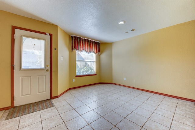 tiled entrance foyer with a wealth of natural light and a textured ceiling