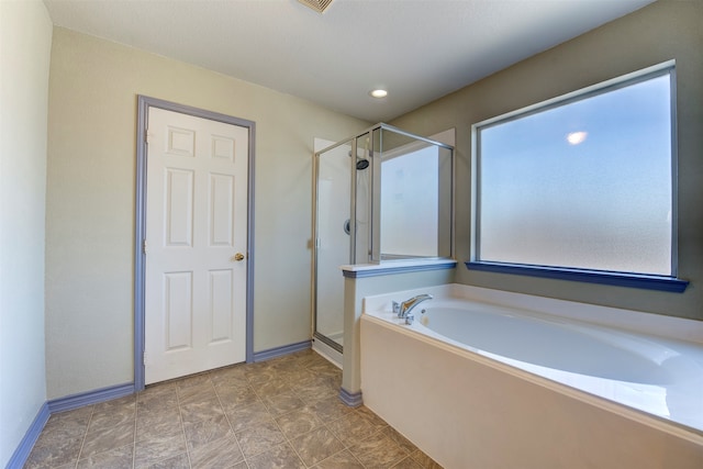 bathroom with shower with separate bathtub