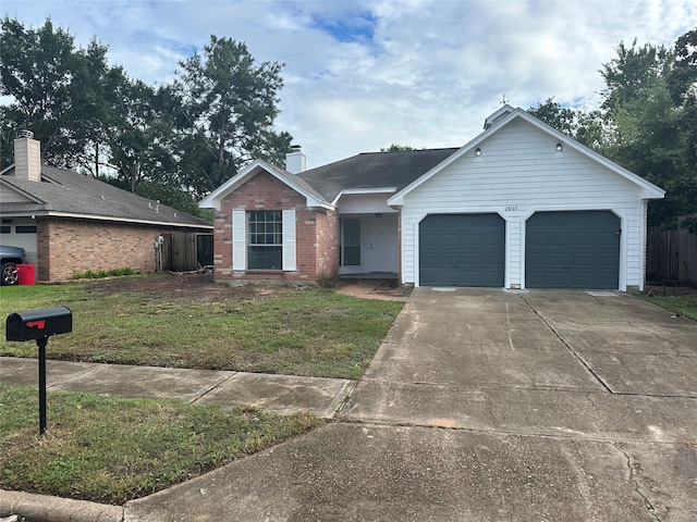 single story home with a garage and a front lawn