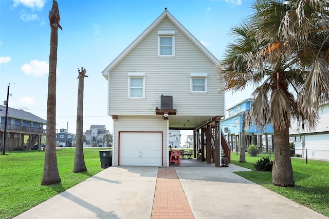 view of front facade with a carport, a garage, and a front lawn