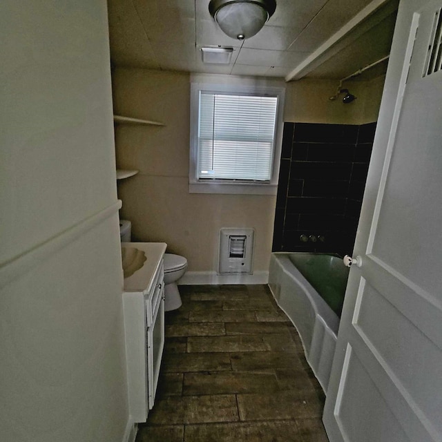 full bathroom with shower / bathtub combination, vanity, heating unit, wood-type flooring, and toilet