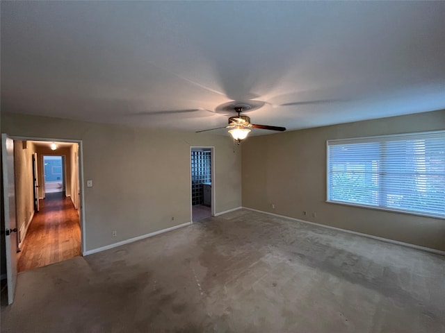 carpeted empty room with ceiling fan