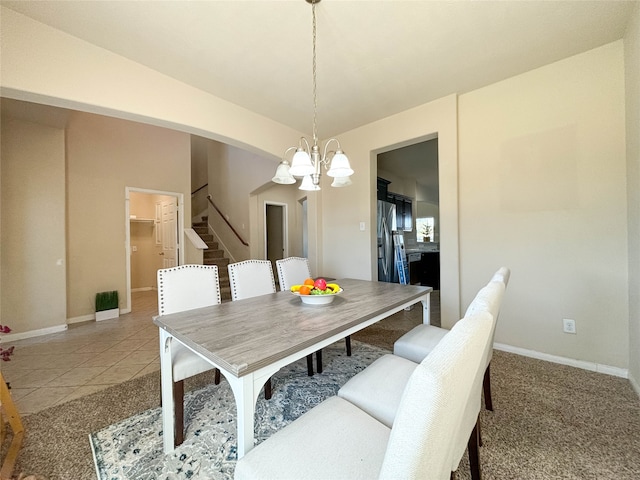 dining area featuring light carpet, vaulted ceiling, and an inviting chandelier