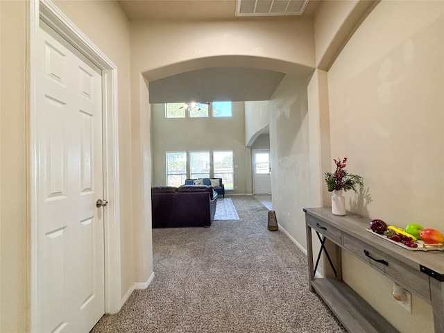 hallway with light colored carpet