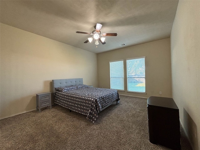 bedroom featuring ceiling fan and dark colored carpet