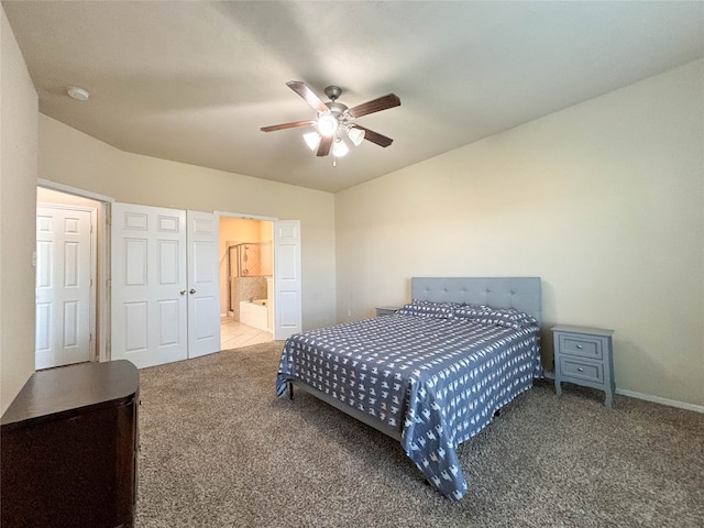 bedroom featuring ceiling fan, carpet floors, and ensuite bath