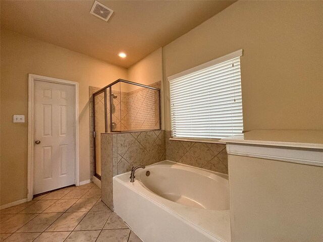 bathroom featuring tile patterned flooring and separate shower and tub