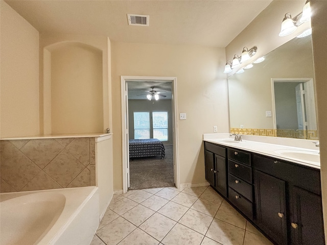 bathroom with a bathtub, ceiling fan, tile patterned flooring, and vanity