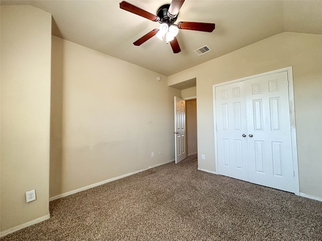 unfurnished bedroom featuring carpet flooring, ceiling fan, a closet, and vaulted ceiling