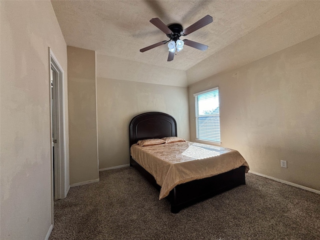 carpeted bedroom featuring ceiling fan and a textured ceiling