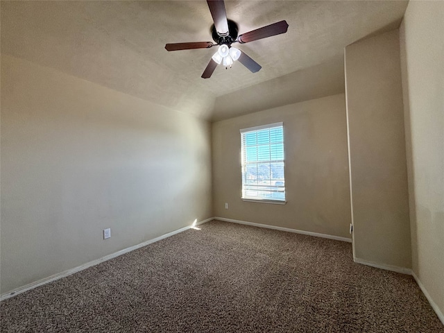 empty room with a textured ceiling, ceiling fan, carpet floors, and lofted ceiling