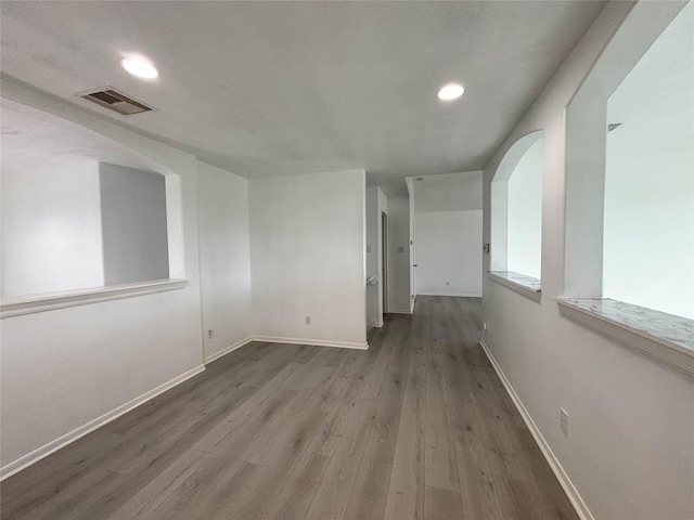 spare room with hardwood / wood-style floors