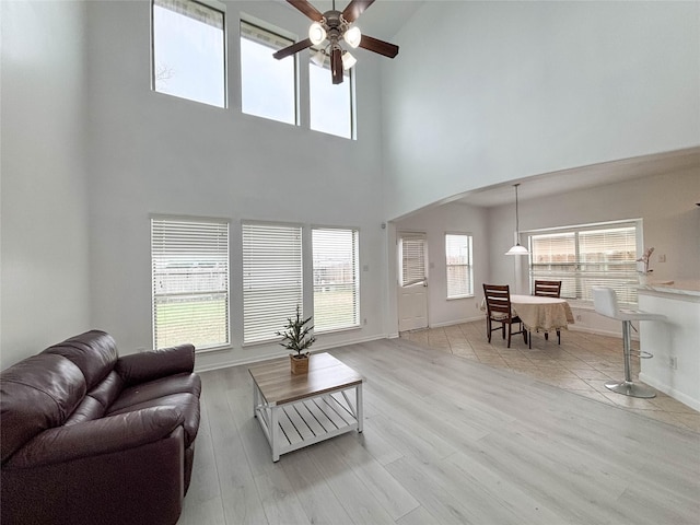 living room with ceiling fan and light wood-type flooring