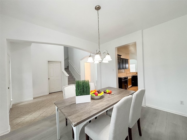 dining area with a chandelier and light hardwood / wood-style floors