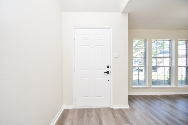 doorway with light wood-type flooring