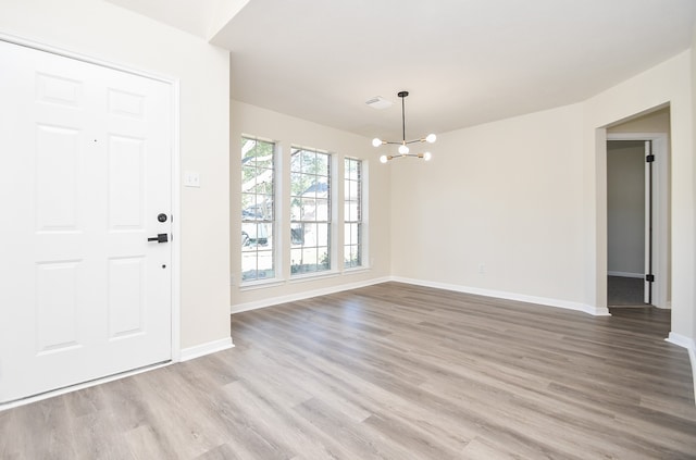 entryway featuring a chandelier and light hardwood / wood-style flooring