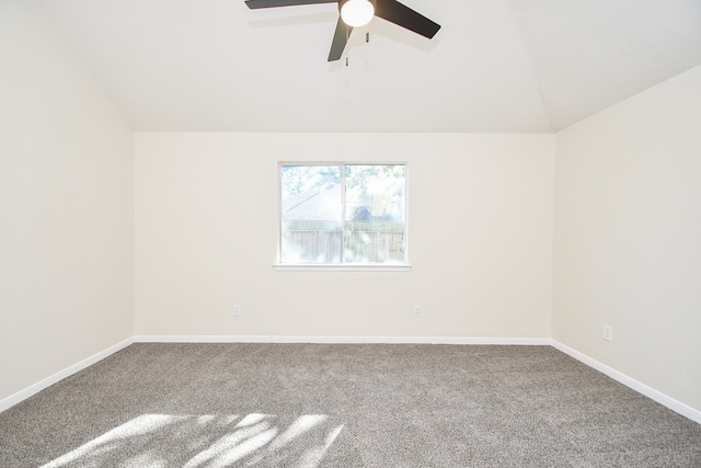 carpeted empty room with ceiling fan and lofted ceiling