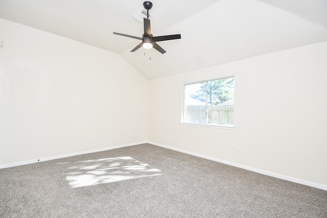 spare room featuring carpet flooring, ceiling fan, and vaulted ceiling