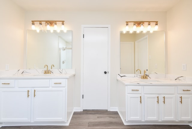 bathroom featuring a shower, wood-type flooring, and vanity