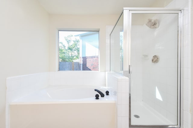 bathroom featuring separate shower and tub