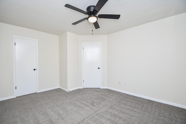 unfurnished room with ceiling fan and carpet floors