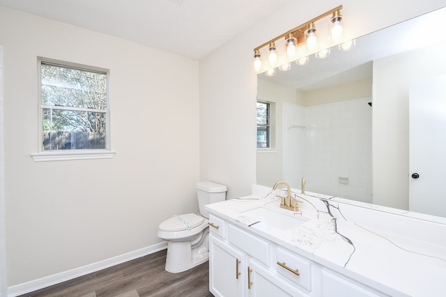 bathroom with hardwood / wood-style floors, vanity, toilet, and plenty of natural light