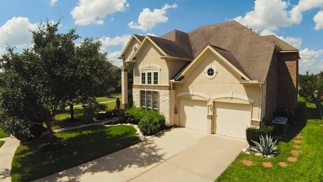 view of front of house featuring central air condition unit, a front lawn, and a garage