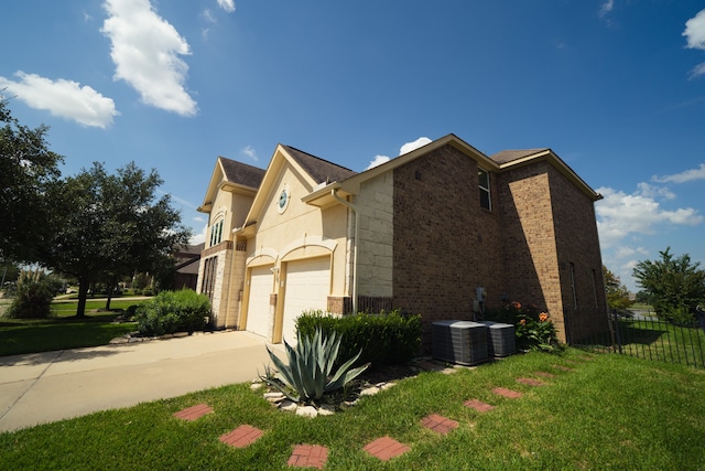 view of property exterior featuring a lawn, a garage, and central AC