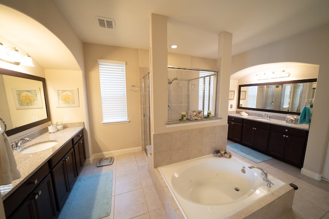 bathroom with tile patterned flooring, vanity, and independent shower and bath