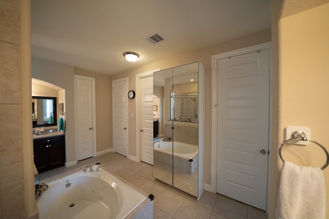 bathroom with tile patterned flooring, vanity, and separate shower and tub