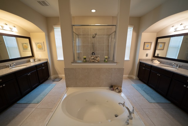 bathroom with tile patterned floors, vanity, and separate shower and tub