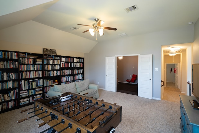 interior space featuring ceiling fan, light colored carpet, and lofted ceiling