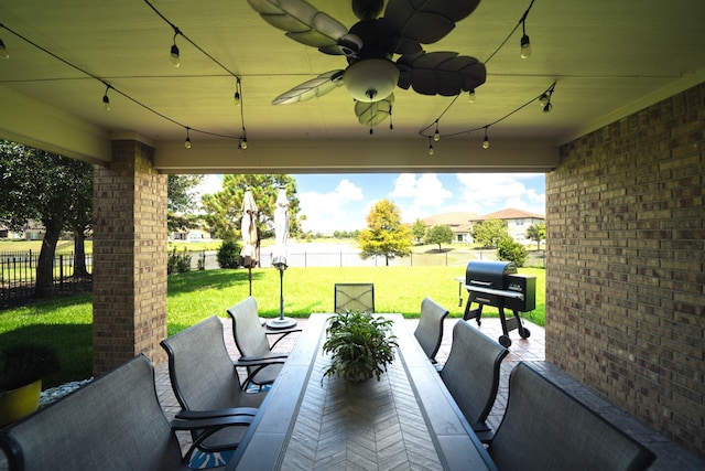 view of patio with area for grilling and ceiling fan