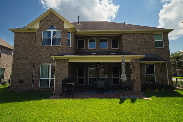 rear view of property with a yard