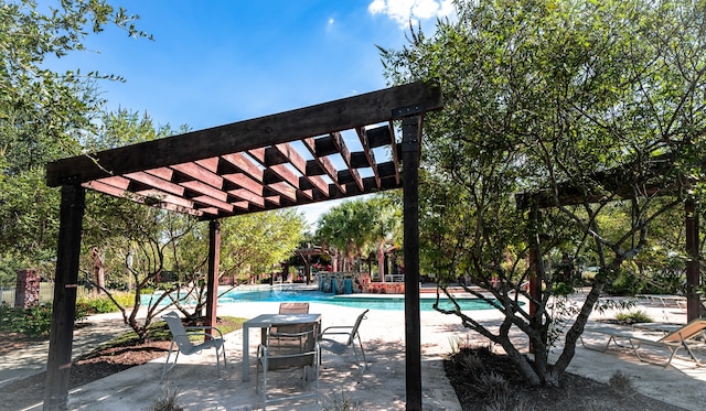 view of swimming pool featuring pool water feature and a pergola