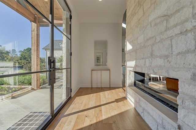 hallway featuring plenty of natural light and hardwood / wood-style flooring