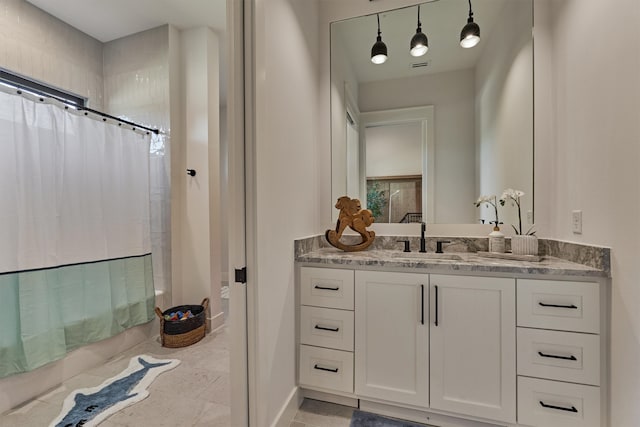 bathroom with tile patterned floors, vanity, and shower / tub combo with curtain