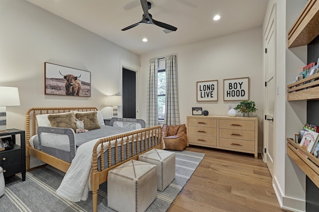 bedroom with light wood-type flooring and ceiling fan